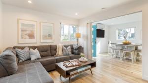 a living room with a couch and a table at Velvet Sand II by AvantStay Steps to Newport Beach in Newport Beach