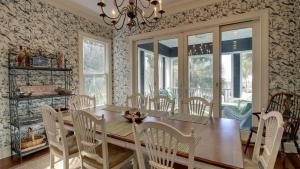 a dining room with a wooden table and chairs at 3902 Palm Blvd by AvantStay Beach Access Oceanfront Views w Pool in Isle of Palms