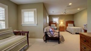 a bedroom with two beds and two windows at 3902 Palm Blvd by AvantStay Beach Access Oceanfront Views w Pool in Isle of Palms +15 photos