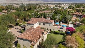 an aerial view of a house with a yard at Villa del Gallo by AvantStay Luxury Group Retreat Pool Putting Green in Bermuda Dunes