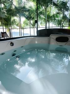 a bath tub with a glass floor in a building at Cabana Vista Ilha/Santo Amaro da Imperatriz in Santo Amaro da Imperatriz