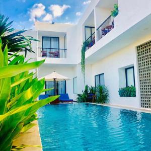 a villa with a swimming pool in a resort at Flex Suites in Phum Pobos +16 photos