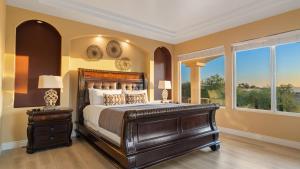 a bedroom with a large bed and a window at Via del Sur by AvantStay Private Spanish Villa w Views Walk to Wineries in Temecula +66 photos