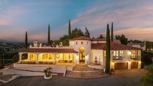 a large white house with trees in front of it at Via del Sur by AvantStay Private Spanish Villa w Views Walk to Wineries in Temecula