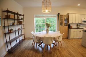 a kitchen and dining room with a table and chairs at The Gentry Hideaway, A Private Mayberry Retreat in Mount Airy