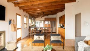 a living room with a table and chairs at Camden by AvantStay 5mins to the Beach Elevated Home w Pacific Ocean Views in Encinitas