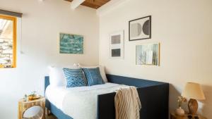 a bedroom with a bed with blue and white pillows at Camden by AvantStay 5mins to the Beach Elevated Home w Pacific Ocean Views in Encinitas