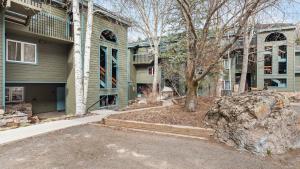 a large rock in front of a house with a tree at Riverside Condos B101 by AvantStay Condo Close To Downtown Town Park Ski Lift 8 in Telluride