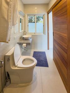 a bathroom with a toilet and a sink at BANTAI White House in Amphoe Koh Samui