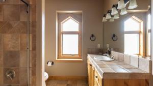 a bathroom with a sink and a shower at Highline by AvantStay Breathtaking Mountain Home w Hot Tub Views in Vail +27 photos