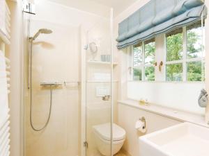 a bathroom with a shower and a toilet and a sink at Min-Go in Kampen