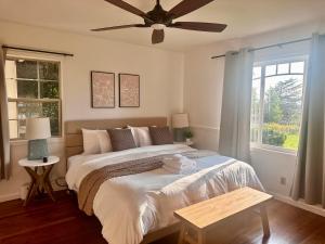 a bedroom with a bed with a ceiling fan at Farmhouse Rv - Sunset Pergola - Fire Pit - Views in Jacksonville