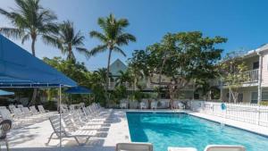 a swimming pool with lounge chairs and a hotel at Beach House Condo by AvantStay Communal Pool Gated Community Great Location Week Long Stays in Key West