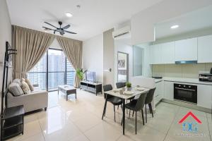 a kitchen and living room with a table and chairs at Astoria Ampang By Grabstay in Kuala Lumpur