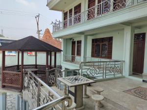 a balcony of a house with a table and a gazebo at Vafa Guesthouse in Cianjur