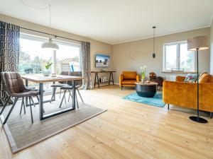 a dining room and living room with a table and chairs at Haus-Fahnert-2 in Kampen