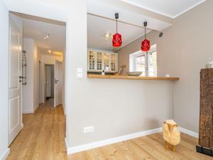 a living room with white walls and wood floors at Haus-Fahnert-2 in Kampen +2 photos