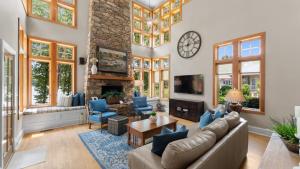 a living room with a couch and a fireplace at Boathouse Cove by AvantStay Pool Swim Dock Hot Tub in Lake Norman of Catawba