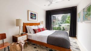 a bedroom with a bed and a large window at Marquee By AvantStay Modern Stylish Estate w Pool Entertainers Courtyard in Boyes Hot Springs +25 photos