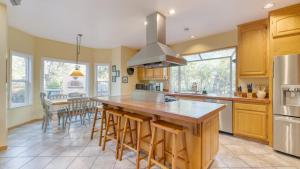 a kitchen with a large island with bar stools at Valley of the Moon by AvantStay Tranquil Escape Large Yard w Hot Tub Fire Pit in Kenwood