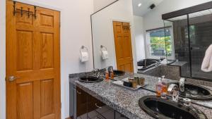 a bathroom with two sinks and a large mirror at Valley of the Moon by AvantStay Tranquil Escape Large Yard w Hot Tub Fire Pit in Kenwood +51 photos