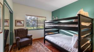 a bedroom with two bunk beds and a chair at Valley of the Moon by AvantStay Tranquil Escape Large Yard w Hot Tub Fire Pit in Kenwood
