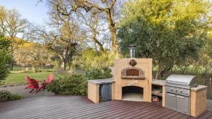 a outdoor oven and grill on a wooden deck at Valley of the Moon by AvantStay Tranquil Escape Large Yard w Hot Tub Fire Pit in Kenwood