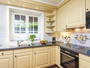 a kitchen with white cabinets and a sink at Hansenhoog-4 in Kampen