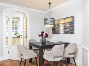 a dining room with a black table and chairs at Hansenhoog-4 in Kampen