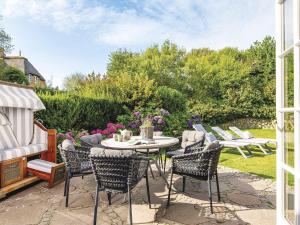 a patio with a table and chairs in a yard at Hansenhoog-4 in Kampen