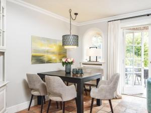 a dining room with a black table and chairs at Hansenhoog-3 in Kampen
