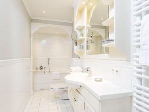 a white bathroom with a sink and a toilet at Hansenhoog-3 in Kampen