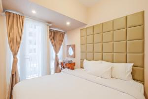 a bedroom with a large bed and a window at Tokyo Riverside Apartment @ PIK 2 in Tangerang +48 photos