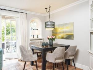 a dining room with a black table and chairs at Hansenhoog-2 in Kampen +5 photos
