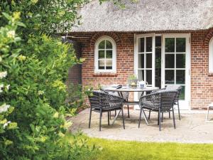 a patio with a table and chairs in front of a building at Hansenhoog-2 in Kampen