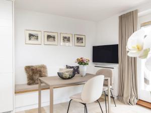 a living room with a table and chairs and a tv at Kliffsand-3 in Kampen