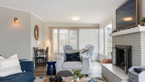 a living room with a blue couch and a fireplace at Harrington Hideaway by AvantStay Beach Access in Coupeville