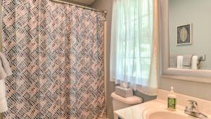 a bathroom with a shower curtain and a sink at Best of the Blue Ridge by AvantStay A Location in Royal Pines +21 photos
