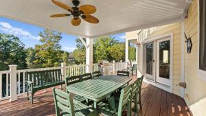 a porch with a green table and chairs at Lakefront 6BDR Priv Dock Game Room Firepit Jakes Lake House by Avantstay in Westport