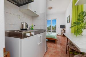 a kitchen with a sink and a counter top at Apartments by the sea Drasnice, Makarska - 24869 in Drasnice