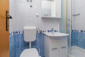 a bathroom with a toilet and a sink at Apartments by the sea Drasnice, Makarska - 24869 in Drasnice +24 photos