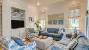a living room with blue furniture and a flat screen tv at Destin Dream by AvantStay 2-Story Home Walk to Beach in Destin