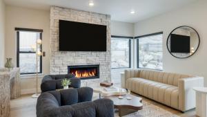 a living room with a couch and a fireplace at Ski La Vie by AvantStay Hot Tub Game Room Near the Ski Slopes in Heber City