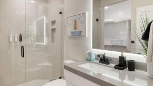 a white bathroom with a sink and a shower at Ski La Vie by AvantStay Hot Tub Game Room Near the Ski Slopes in Heber City +43 photos