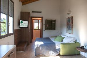 a bedroom with a bed and a table and a window at Residenza Del Parco in Vigevano