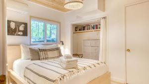a bedroom with a bed and a window at 2 Decks w Lake Glimpse Views Modern Luxe Cabin A-Frame Retreat by AvantStay in Lake Arrowhead
