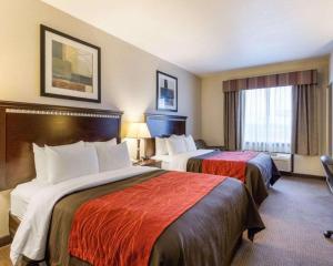 a hotel room with two beds and a window at Comfort Inn & Suites in Winnie +68 photos