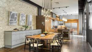 a kitchen and dining room with a table and chairs at Paramount Place by AvantStay 4 Story Apartment in Heart of Austin w Movie Theatre in Austin