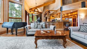 a living room with a table and a piano at Cherry Ridge by AvantStay Incredible Mountain Mansion w Game Room Hot Tub Views in Breckenridge