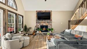 a living room with a couch and a fireplace at Lakeview Sunset Heaven Waterfront Escape Private Dock Firepit Game Room New Construction in Blakeslee